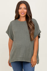 woman wearing an olive green ribbed maternity top, relaxed fit with short sleeves and a round neckline