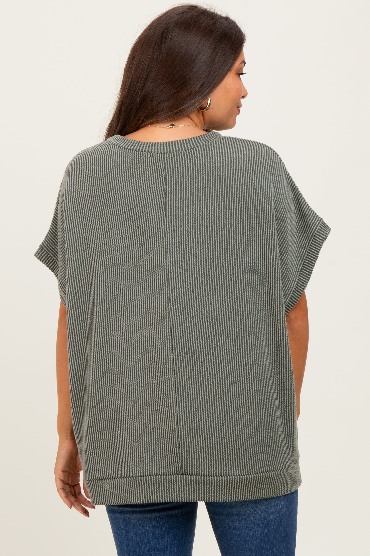 woman wearing a loose-fit olive green ribbed maternity top, shown from the back with short sleeves