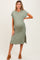 woman wearing a green ribbed maternity dress with side slits and a visible baby bump