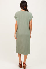 woman wearing a sage green ribbed midi dress with short sleeves and a relaxed fit, viewed from the back