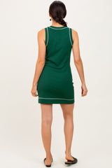 woman wearing a green sleeveless mini dress with contrasting seams, shown from the back