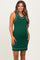 woman wearing a dark green ribbed maternity dress with contrasting trim and a visible baby bump