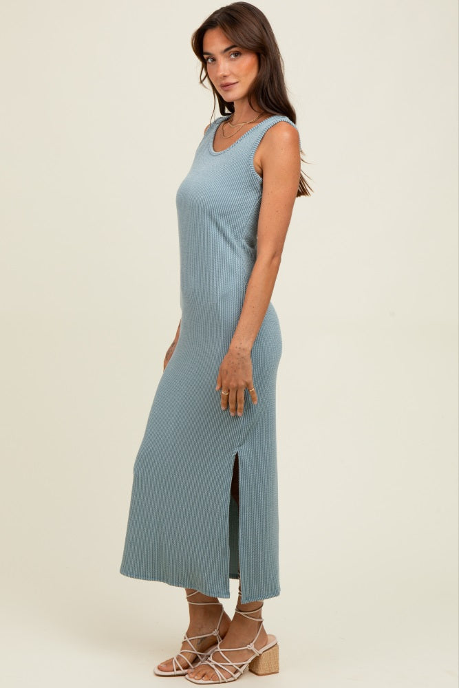 woman wearing a ribbed light blue sleeveless maxi dress with side slits and a form-fitting silhouette