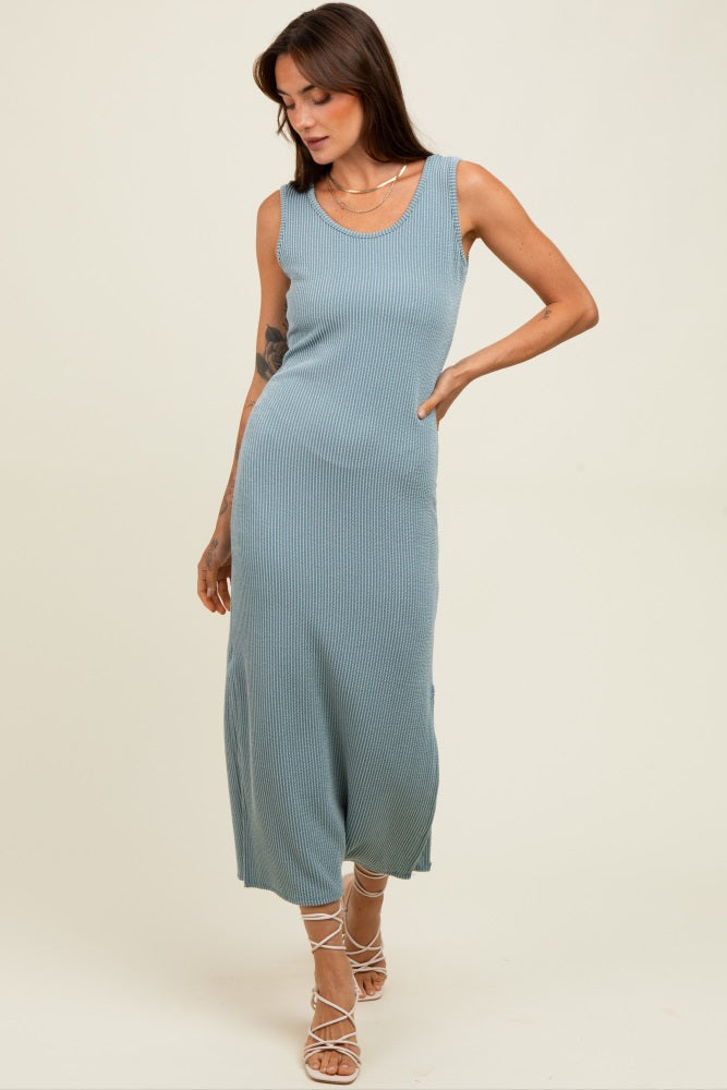 woman wearing a blue ribbed sleeveless maxi dress with a scoop neckline and a fitted silhouette