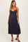 woman wearing a navy blue maternity dress with a bow detail and a visible baby bump