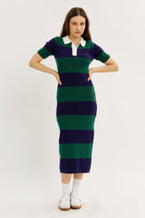 woman wearing a striped midi dress in green and navy with a white collar and short sleeves, paired with white sneakers