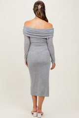 woman wearing a gray off-shoulder maternity dress with long sleeves and a fitted midi length