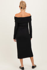 woman wearing a black off-shoulder maternity dress with ruched detailing and long sleeves
