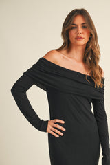 woman wearing a black off-the-shoulder long sleeve dress with a fitted silhouette