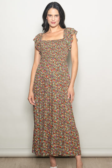 woman wearing a floral smocked maxi dress with ruffled sleeves and a square neckline