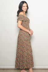 woman wearing a brown floral off-the-shoulder maxi dress with ruffled sleeves and a fitted bodice