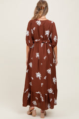 woman wearing a brown floral maxi dress with puff sleeves and a belted waist, showcasing a beautiful maternity style