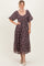 woman wearing a dark floral midi dress with short puff sleeves and a square neckline