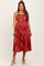 woman wearing a red floral maternity dress with adjustable straps and a flowing skirt, showcasing her baby bump