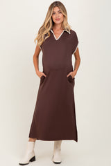 woman wearing a brown maternity maxi dress with a white collar and pockets