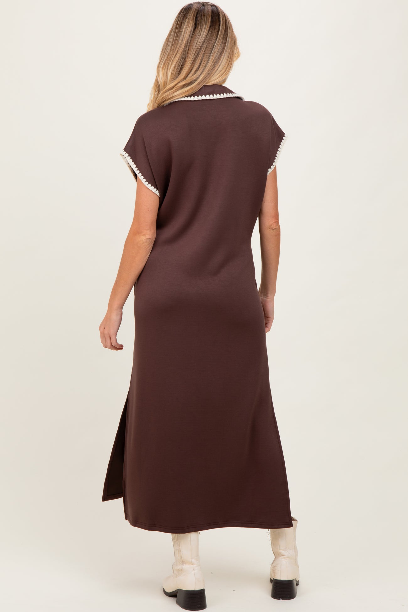 woman wearing a brown maternity maxi dress with short sleeves and side slits, model seen from the back
