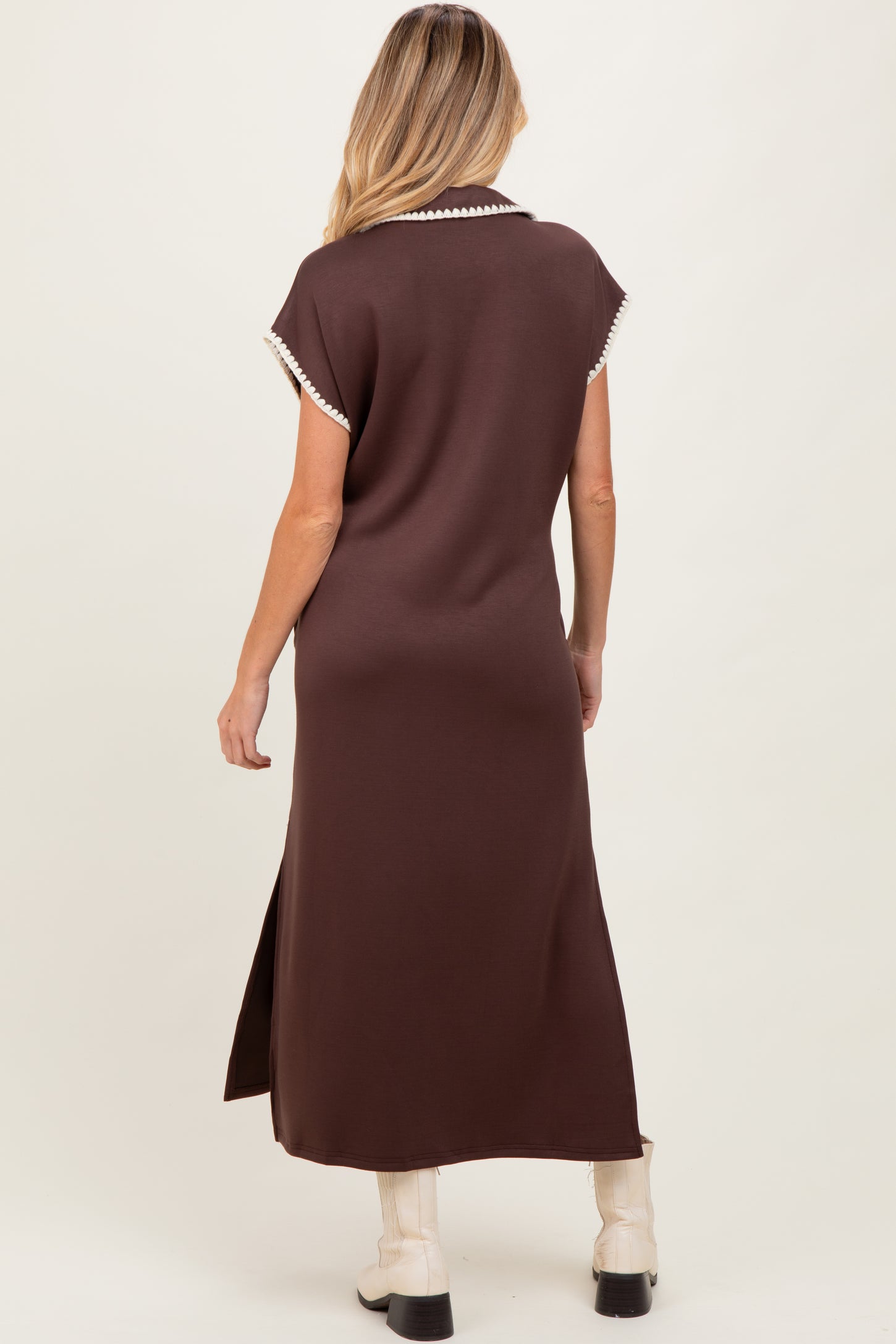woman wearing a brown maternity maxi dress with short sleeves and side slits, model seen from the back