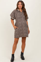 woman wearing a leopard print short sleeve maternity dress with side pockets and a collar