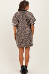 woman wearing a brown leopard print maternity dress with short sleeves and a relaxed fit, showing the back view
