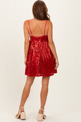woman wearing a red sequin party dress with a fitted bodice and flared skirt, showcasing the back view