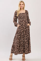 woman wearing a brown floral long sleeve maxi dress with a square neckline and pockets