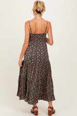 woman wearing a dark green floral maternity maxi dress with smocked back and tiered skirt, view from the back
