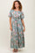 woman wearing a long floral print maxi dress in light teal with short flutter sleeves