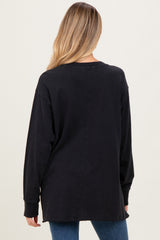 woman wearing a black long sleeve maternity top, back view, with a relaxed fit and side slits