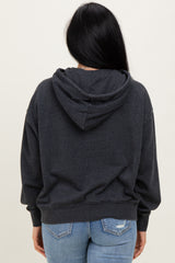 woman wearing a dark gray hoodie from the back with a hood and relaxed fit, paired with light blue jeans