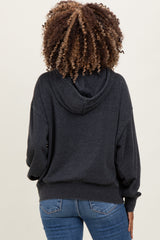 woman wearing a dark gray maternity hoodie with a relaxed fit, showing the back view and paired with blue jeans