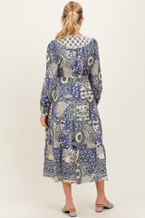 woman wearing a floral print maternity dress with long sleeves and a gathered skirt, showcasing the back view