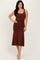 woman wearing a brown sleeveless ruched midi dress with a flared hem and standing pose
