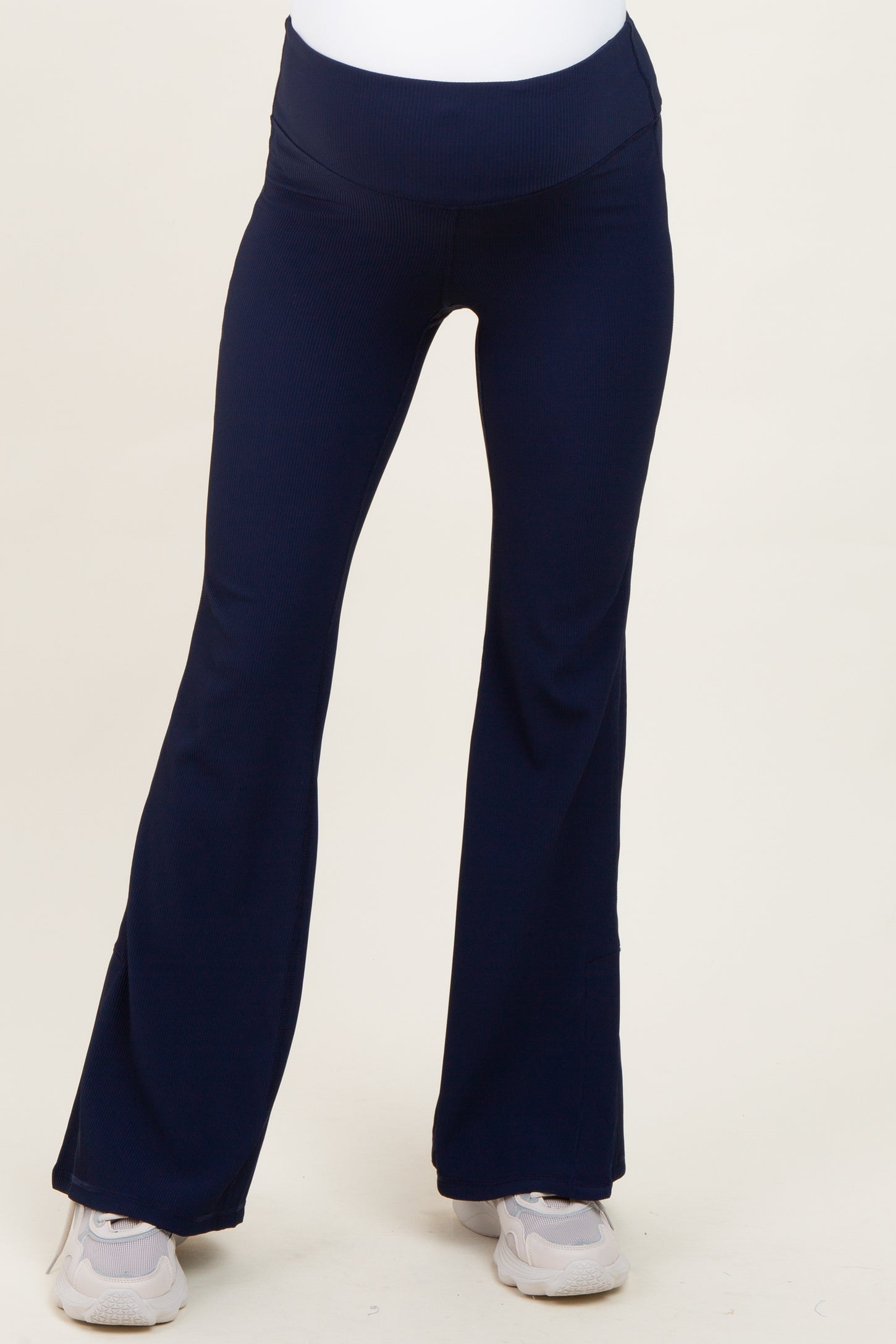 woman wearing navy blue maternity yoga pants with a flared leg and a high waistband
