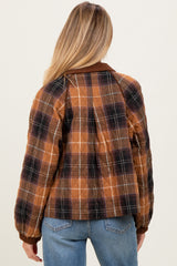 woman wearing a brown plaid maternity bomber jacket with puffed sleeves and a relaxed fit