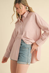 woman wearing a light pink striped long sleeve shirt with a pocket and denim shorts