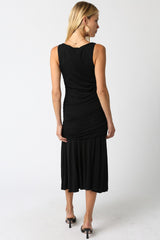 woman wearing a black sleeveless midi dress with ruched details and a flared skirt, shown from the back