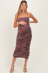 woman wearing a brown and purple striped maternity dress with ruching and a visible baby bump