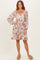 woman wearing a floral print square neck dress with long puff sleeves and a relaxed fit