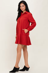 woman wearing a red ribbed long sleeve dress with a flared hem and side pockets
