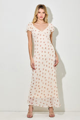 woman wearing a cream floral maxi dress with short puff sleeves and a v-neckline