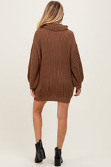 woman wearing a brown oversized knitted maternity sweater with a cowl neck and long sleeves