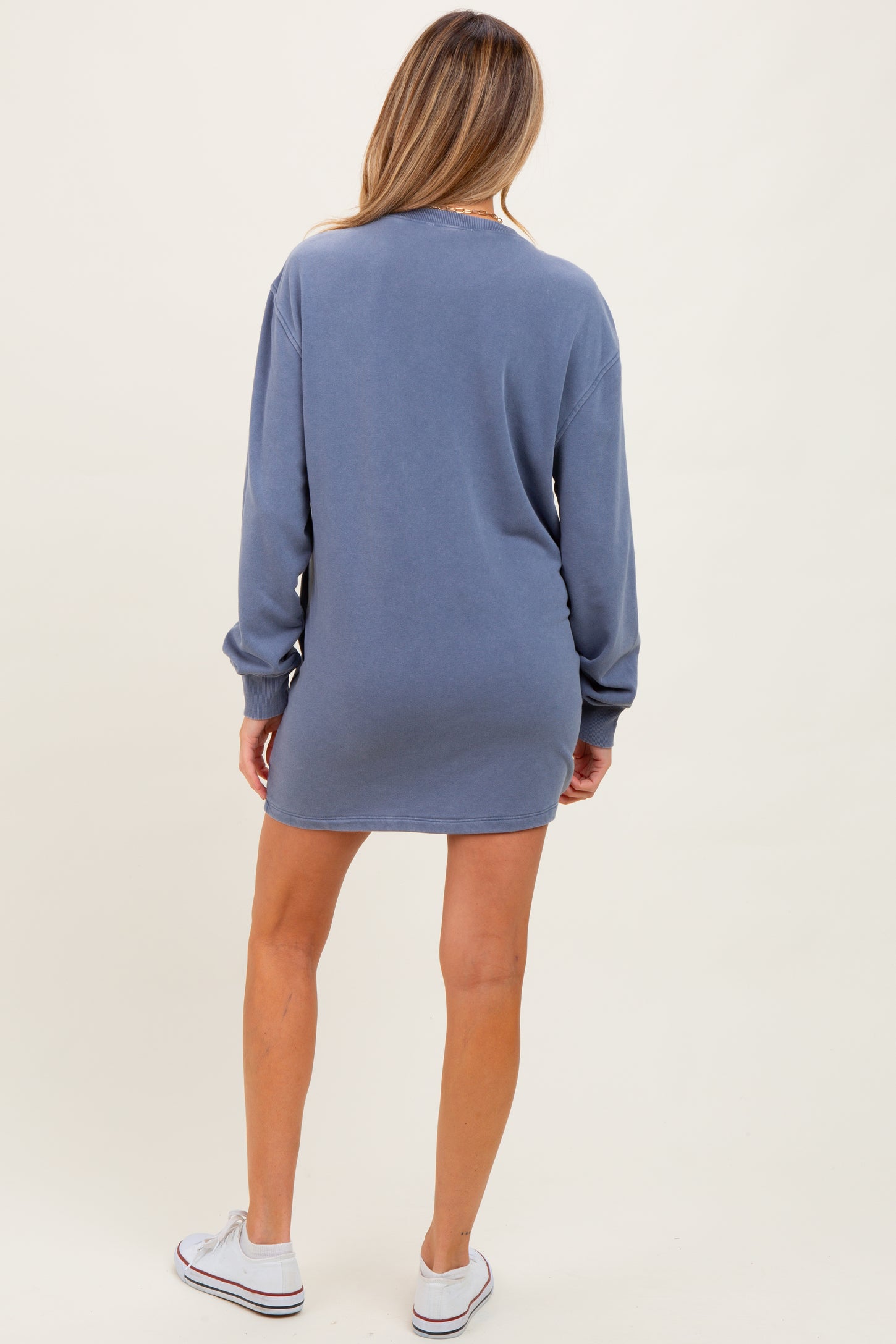 woman wearing a blue long sleeve maternity dress, showing a relaxed fit from the back