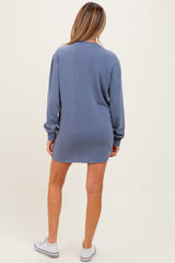 woman wearing a blue long sleeve maternity dress, showing a relaxed fit from the back