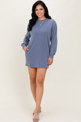 woman wearing a blue long sleeve casual dress with pockets and a relaxed fit