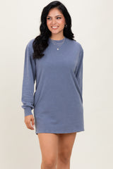 woman wearing a blue long sleeve oversized sweatshirt dress with a relaxed fit and round neckline