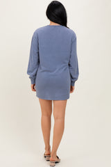 woman wearing a back view of a blue long sleeve sweatshirt dress with a relaxed fit