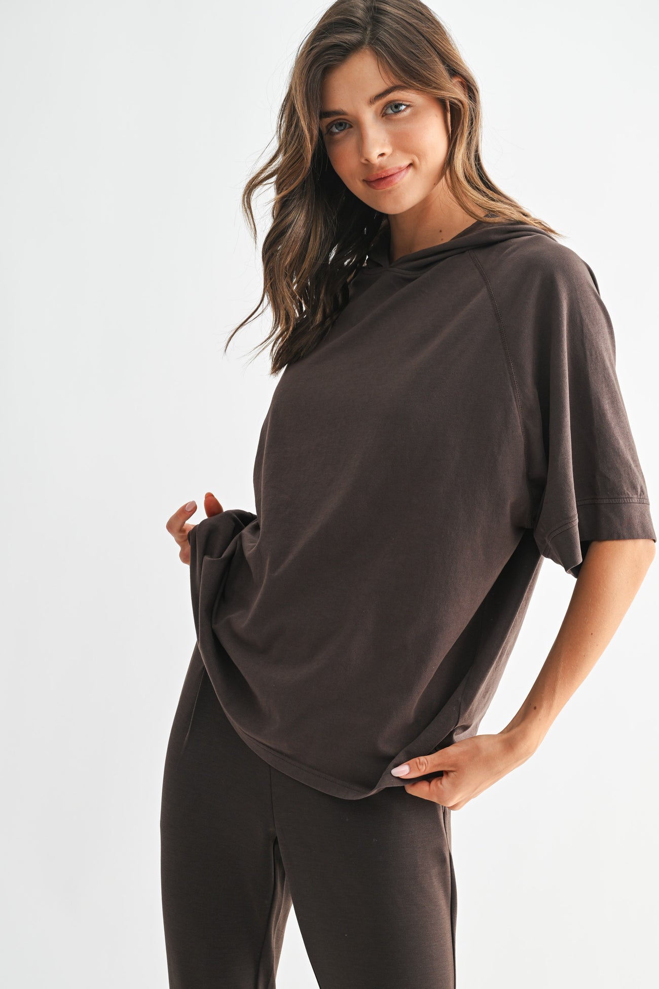 woman wearing a relaxed fit dark brown oversized t-shirt with short sleeves and a casual style