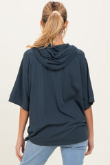 woman wearing a navy blue oversized hoodie with a hood, shown from the back, maternity wear