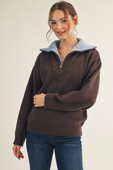 woman wearing a brown zip-up pullover sweater with a light blue collar and casual jeans