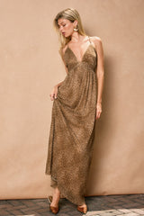 woman wearing a brown leopard print maxi dress with a deep V-neck and spaghetti straps